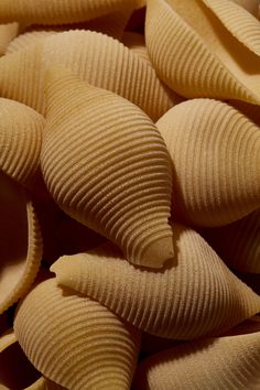 some pasta shells are piled on top of each other in this close up photo,