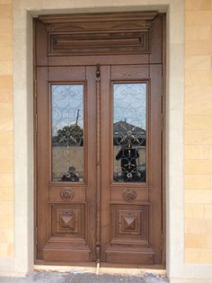 two brown doors with glass on each side