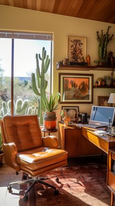 an office with a desk, chair and cactus in front of a large window that looks out onto the desert