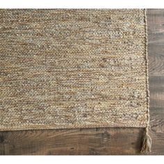 the handmade rug is made from natural materials and has fringed ends on each side