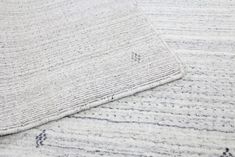 the textured rug is white and grey