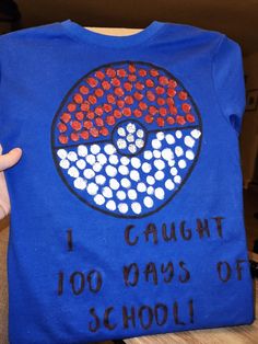 a blue t - shirt with the words i caught 100 days of school on it