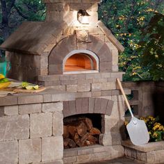 an outdoor brick oven with a shovel next to it