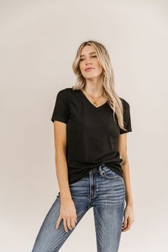 Our V Neck Tee's are another fan-favorite here at Ampersand Avenue. They might be your new go-to tee! They feature medium stretch with slightly longer sleeves to provide you with all-day comfort! V Neck Lulu Tee- Black: Medium Stretch // TTS for a slim fit, size up for a looser fitMaterial: 35% cotton, 60% polyester, 5% spandex Kloee is wearing a size Small. Holiday Hoodies, Denim Leggings, Basic Outfits, Romper With Skirt, Basic Tee, V Neck Tee, Black Tee, No Matter What, Sweater Hoodie