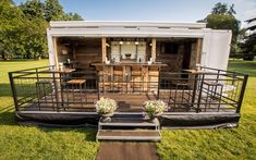 an outdoor dining area on the back of a mobile home