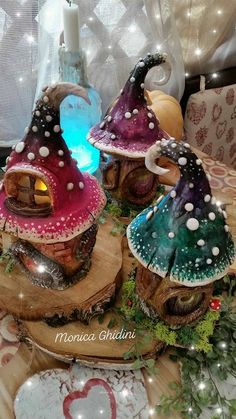 three gnome houses sitting on top of a wooden table