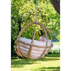 a child is sitting in a wooden swing