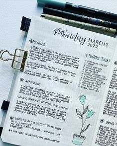 an open bible with the words monday march written on it next to two pens and a clipboard