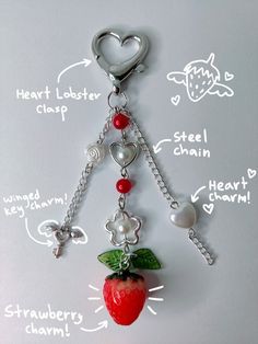 a key chain with charms attached to it and an apple on the side, labeled in words