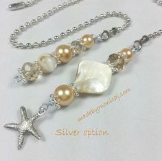 a necklace with pearls and a starfish on it