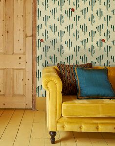 a yellow couch sitting in front of a wooden door