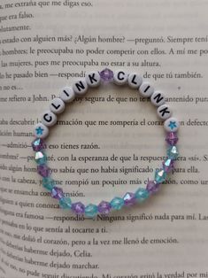 a bracelet with words that spell out the word clinkclaw on it's side