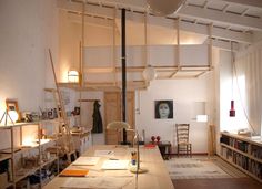 a living room filled with furniture and bookshelves