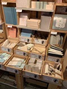 the shelves are filled with many different types of cards and envelopes in boxes on them