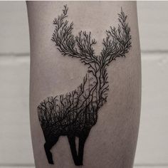 a tattoo on the leg of a person with trees growing out of their butts