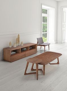 a living room with wooden furniture and white walls