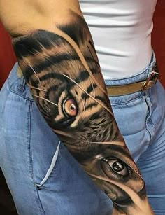 a man with a tiger tattoo on his arm