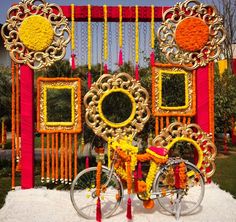 a bike is parked in front of a decorated gate with flowers and decorations on it