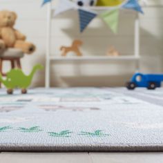 a child's room with toys on the floor and stuffed animals in the background