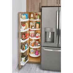 an organized pantry in the corner of a kitchen with stainless steel refrigerator and wooden cabinets