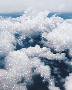 the sky is filled with lots of white fluffy clouds and sparkling sparkles on them