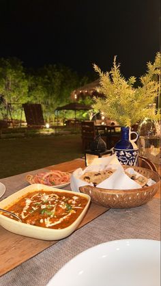 a table topped with plates and bowls filled with food