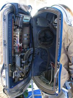 the inside of an astronaut's space suit with its door open and equipment in it