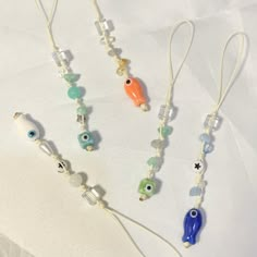 three necklaces with evil eyes and beads