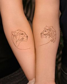 two people with matching tattoos on their arms, one has a lion and the other has a bear's head