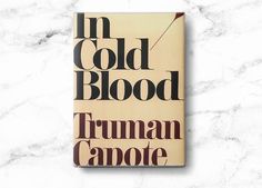 the book in cold blood by truman camote is on a marble surface with black ink