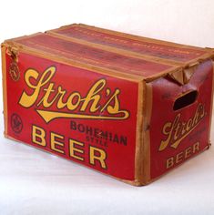 an old style beer box sitting on a white surface