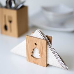 a wooden napkin holder with a christmas tree cut out of it's front and side