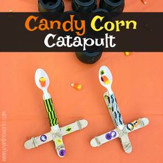 the candy corn catapult is made out of plastic spoons