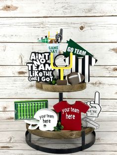 three tiered wooden stand with football themed items on it and the words team, you're here