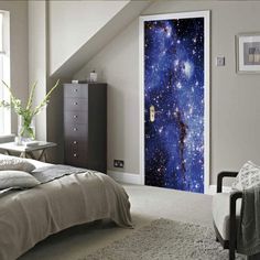 an open door to a bedroom with a crescent moon and stars in the night sky