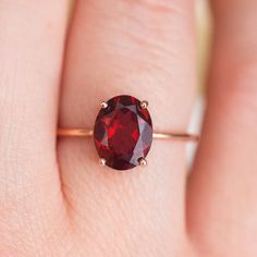 How can something so simple as an oval Garnet solitaire ring, be so beautiful, you ask? The answer is in the gemstone itself. With a gorgeous vivid and deep red color, this ring just pops out on your finger and dazzles everyone. To turn it up a notch, add complimentary stacking rings, to create a one-of-a-kind ring set Simple Color Gem Ring, Luxury Oval Garnet Birthstone Ring, Luxury Garnet Oval Cabochon Rings, Planet Ring, Garnet Gem, Moss Agate Ring, Baguette Ring, Rose Quartz Ring, Deep Red Color