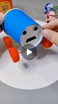 someone is making a paper toy that looks like an airplane with a face on it