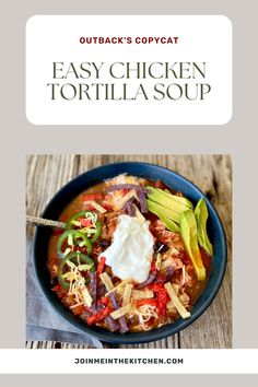 a bowl of chicken tortilla soup with avocado and sour cream on top