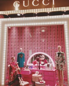 gucci store window display with mannequins and pink furniture