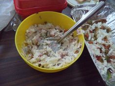 a bowl filled with food sitting on top of a table next to another bowl full of food