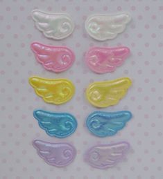 six different colored wings on a white background with polka doted dots and pink, blue, green, yellow, purple, and orange colors