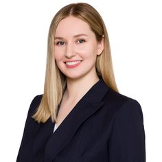 a woman with blonde hair wearing a black suit