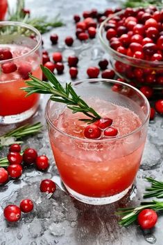 two glasses filled with cranberry punch and garnished with rosemary