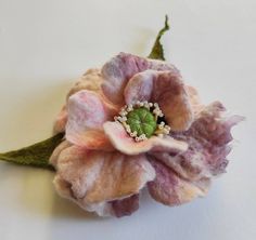 a close up of a flower on a white surface