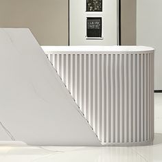 a white reception table with an abstract design on the front and back wall, in a modern office setting