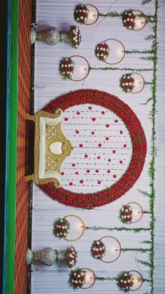 the table is decorated with red and white flowers, silver candles and decorative items on it