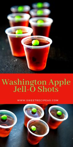 several cups filled with jello and green candies on top of a black table