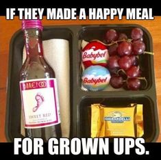 an open lunch box with grapes, crackers, and other food items in it