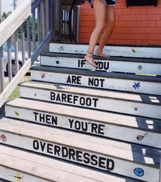 a woman walking up some steps with words on them that read if you are not barefoot, then you're overdressed