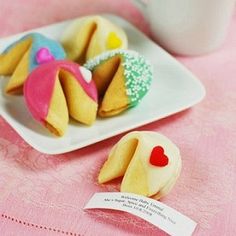 some cookies are sitting on a plate next to a cup of coffee and a card